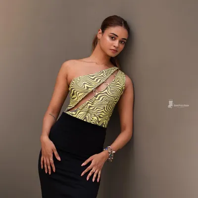 A clean, minimalist studio portrait. The focus is on the subject's pose and the interesting lines of her outfit, showing my versatility in a studio environment.