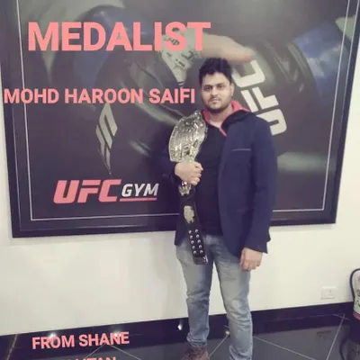 Gold medalist Mohd Haroon Saifi. This is what winning looks like. He holds the championship belt, proof of his skill and the effectiveness of our freestyle MMA training.