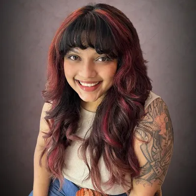 This is Amrapali's rock-chick shag haircut, taken to the next level with fiery red accents. The color placement highlights the edgy layers of the cut.