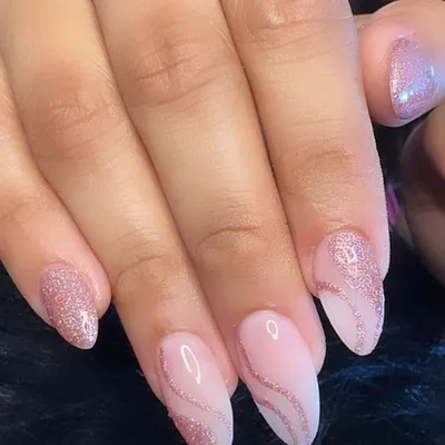 Pink glitter nails for the win! A beautiful combination of a sheer pink base with delicate rose gold glitter swirls.