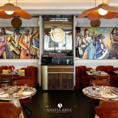 A wide view of the hand-painted jazz murals I created for Chilli Pop restaurant in Delhi. The vibrant, energetic artwork spans multiple walls, setting a lively, musical tone for the entire space.