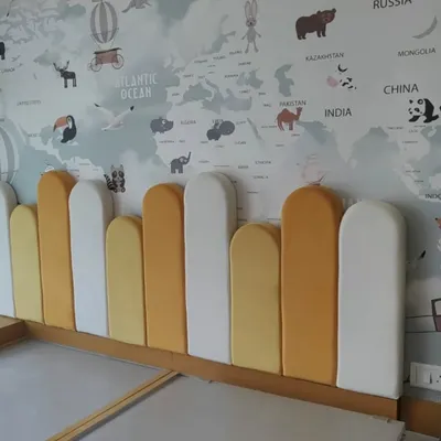 We can bring any theme to life, like this world map wallpaper for a child's room. Paired with a custom-cushioned headboard, it creates a fun and educational space. This is a great example of an accent wall that transforms a room's entire feel.