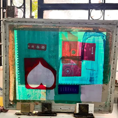 Screen printing. This is a used screen from our workshop, layered with the ghosts of past projects. The heart in the center says it all. We truly love what we do.