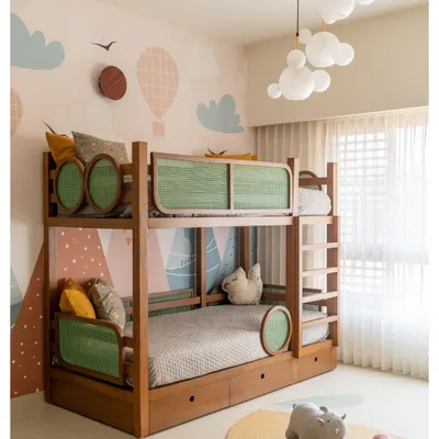 We designed this custom bunk bed with green rattan panels and built-in storage drawers. The whimsical wallpaper and cloud-shaped pendant lights make it a dream space for any child.
