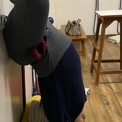 I offer prenatal yoga classes. Here, a pregnant student is in a modified headstand against the wall, which is safe and beneficial for relieving back pressure.