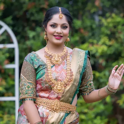 A happy bride wearing one of my classic temple jewellery sets. The set features a Lakshmi pendant haram and choker, perfect for a traditional South Indian wedding.
