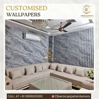 This living room features a combination of two different wall treatments. One wall has a custom wallpaper with a grey marble texture, while the accent wall uses a vertically striped wallpaper, creating a sophisticated and layered interior design.