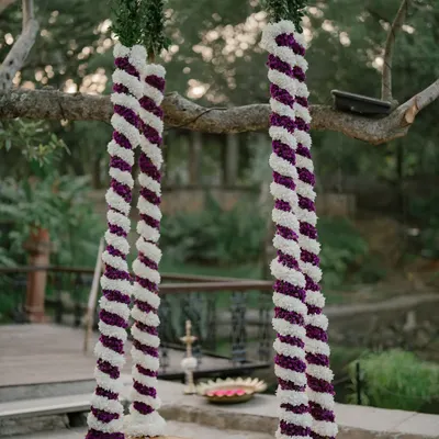 A close-up of our floral swing, decorated with purple and white flowers, ready for a photo session or a traditional oonjal ceremony.