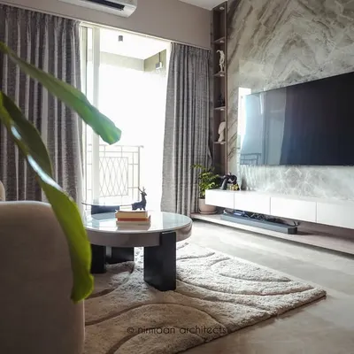 This living room in our Sai World Empire project embodies quiet luxury. The marble-clad TV wall serves as a stunning focal point, balanced by soft furnishings and warm, layered lighting for a cozy yet sophisticated feel.