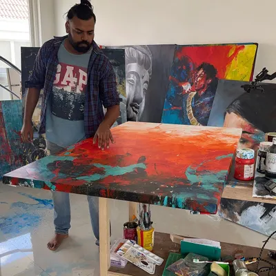 In my studio, working on 'The Uprising', a 5x3 feet abstract. This is where the magic happens, surrounded by paints, canvases, and inspiration.