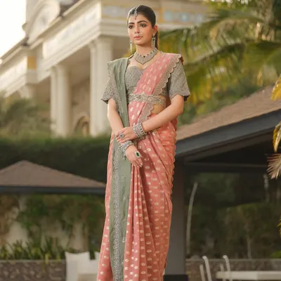 The ethereal allure of a Jayanti Reddy saree. The combination of dusty pink and sage green, paired with traditional jewellery, creates a look of quiet, sophisticated elegance.