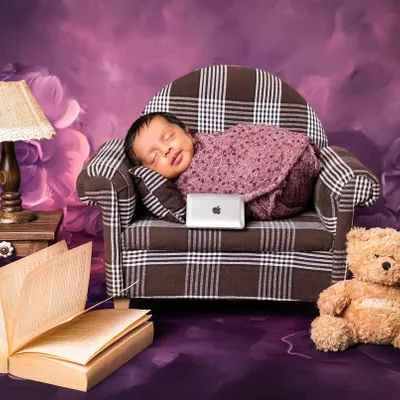 Meet the new boss. This playful "Boss Baby" theme features a newborn sleeping on a miniature plaid sofa with a tiny laptop, ready to take over the world one nap at a time.