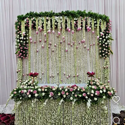 For a truly breathtaking effect, I designed this magnificent mandap featuring a curtain of thousands of fresh jasmine (mogra) strings. The setup is framed with delicate pink and white flowers, creating a fragrant and visually stunning throne for Bappa.