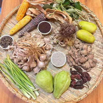 A beautiful flat lay of the ingredients that define Naga cuisine. You can see Zanthoxylum seeds, sticky corn, sumac, local ginger and garlic, Naga lemons, and dried King Chillies.