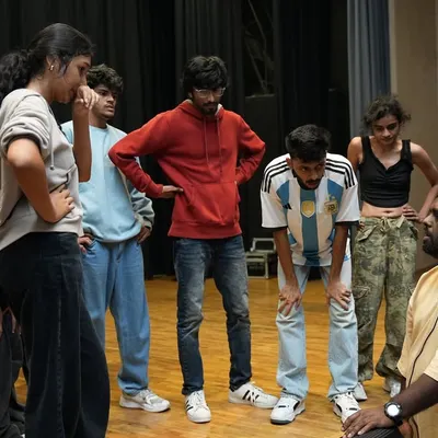 This is where the magic begins. An instructor gives detailed feedback to a group of dancers during a rehearsal for Performance Night.