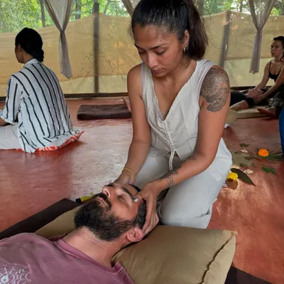Bodywork is a conversation with the body. Here, I am applying gentle pressure to the temples to release tension in the head and face, a common area where we hold stress.