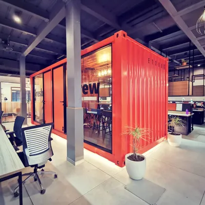 The iconic shipping container meeting room, a central feature of the Tata Hitachi office. This out-of-the-box design solution provides a unique collaborative space and serves as a powerful symbol of the brand's industrial heritage.