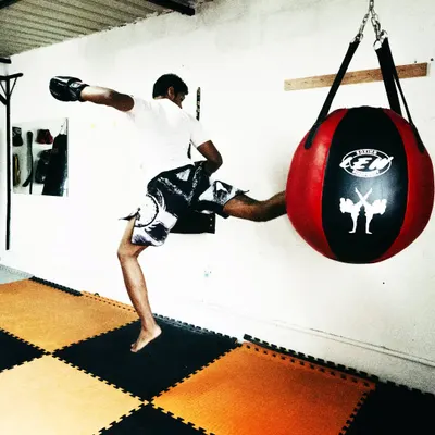 A powerful kick starts from the ground up. This is a flying kick on the wrecking ball, a great drill for developing explosive power and coordination.