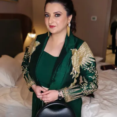 A powerful and glamorous look perfect for a cocktail party or reception. The emerald green outfit is complemented by a sharp, defined eye makeup look and a sleek, pulled-back hairstyle.