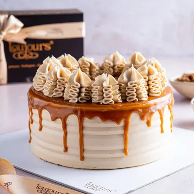 A classic drip cake, perfected. This is my signature salted caramel cake, featuring a beautiful caramel drip and expertly piped buttercream. It's one of the delicious, ready-to-order flavors on my daily menu.