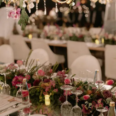 A close-up of the tablescape for Kahran and Gourav's finale dinner. We used mirrored tabletops to reflect the hundreds of chandeliers and floral arrangements above, creating an endless, magical glow for the evening.