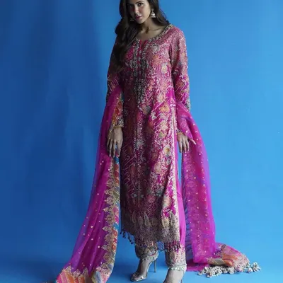 For me, this is Punjab di shaan. I styled this vibrant pink Punjabi suit to highlight the intricate, traditional embroidery while ensuring the fit and drape felt modern and powerful. The bold blue background makes the colors pop.