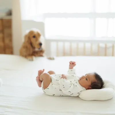 This is a real moment from our home when Caden was just 13 days old. Our dog Luca watching over him from the bed captures the quiet, everyday magic of our new life as a family.