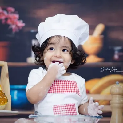 The best part of being a chef is tasting the ingredients. This little one couldn't resist a taste of flour, making for an adorable and funny shot.