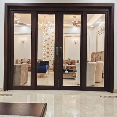 The view into the living room of Villa 9/21B is framed by custom-made wooden and glass doors. This composition highlights our focus on creating layers and depth in our interior architecture, turning a simple doorway into a design feature.
