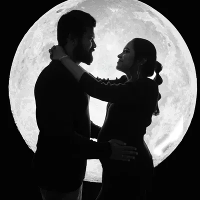 A romantic couple's silhouette against my signature moon backdrop. This is one of my personal favorite styles for creating dramatic and unforgettable maternity portraits.