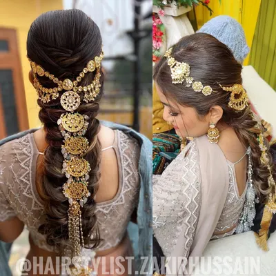 This is a stunning example of a traditional bridal braid heavily accessorized with intricate gold jewelry. The style is both regal and dramatic, perfect for making a grand entrance on your wedding day.