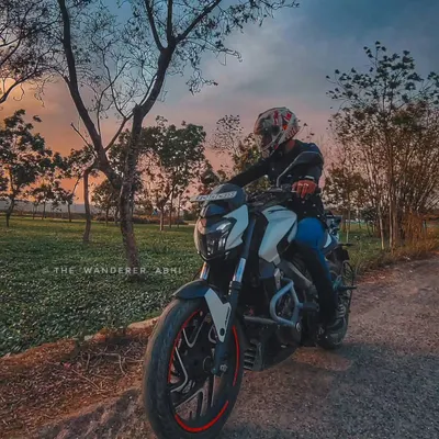 A rider on his white Dominar, pausing to enjoy a stunning sunset over the tea gardens of North Bengal. We always make time to appreciate the view.