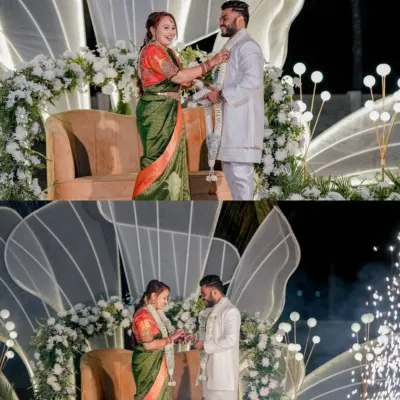 A magical moment captured in front of our modern, lighted reception stage. The couple exchanges garlands as cold pyro fireworks go off, highlighting how our decor creates the perfect backdrop for your most important memories.