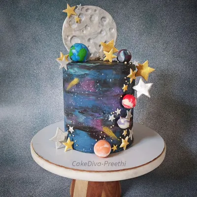 This 12-inch tall double barrel galaxy cake is one of my favorites. I used white chocolate ganache to paint a swirling galaxy effect, then decorated it with a fondant moon, stars, and planets for a truly out-of-this-world result.