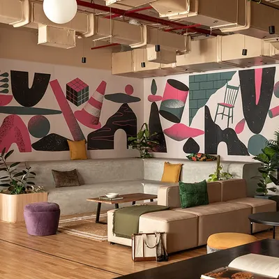 We designed this amphitheater to be a truly versatile hub. It's perfect for large town halls and projection screenings, but the loose furniture allows it to be easily reconfigured for smaller brainstorming sessions or casual work.