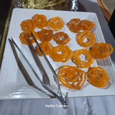 Hot, crispy Jalebis served fresh. This is a classic dessert that we often prepare at live counters, filling the air with its sweet aroma.
