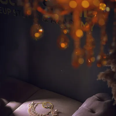 An artistic shot of the bride's necklace and earrings, laid out before she gets ready. The lighting and composition make this a beautiful detail photo.