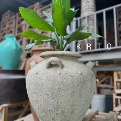 My classic 'Krio' planter in a neutral, sandy finish. The rustic texture and traditional shape with small handles make it a timeless piece.