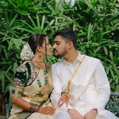 A quiet moment between a couple, captured in a lush garden setting. We focus on the near-kiss and gentle touch to create a feeling of intimacy and romance.