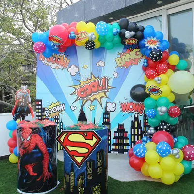 Kapow! A super backdrop for a superhero-themed party, featuring comic book graphics and character stands for Superman and Spider-Man.