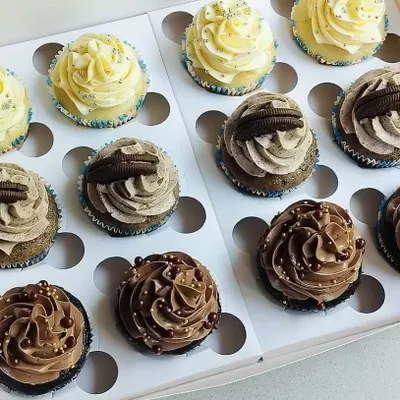 This is my classic assortment box, perfect for any occasion or when you can't decide on just one flavor. It features rows of my signature Chocolate, Vanilla, and Oreo cupcakes, each with its own distinct and delicious topping.