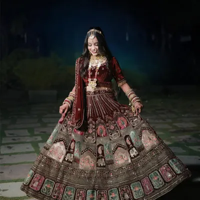 A beautiful full-length portrait of the bride twirling in her intricately designed lehenga. The outdoor setting and her joyful expression perfectly capture the magic of her wedding day.