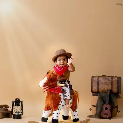 This little cowboy is ready to ride! The rocking horse and vintage luggage create a perfect wild west scene right in my studio.