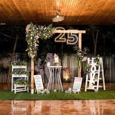 An intimate milestone celebration for a 25th birthday. I created this rustic yet chic setup by a poolside, using a wooden arch, fresh florals, and a custom neon sign to make the birthday girl feel truly special.