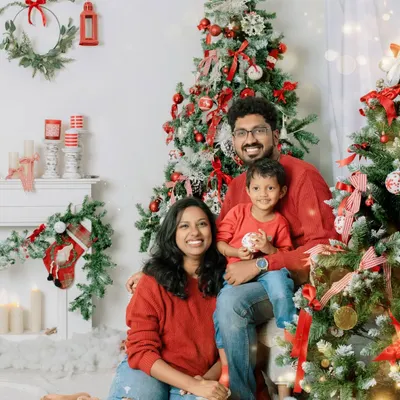A picture perfect holiday moment. This family's coordinated red sweaters and joyful smiles make for a classic Christmas card photo, full of warmth and festive cheer.