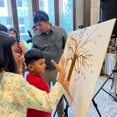 A father and son adding their thumbprints to a family tree canvas. It’s a beautiful way for guests of all ages to leave their mark.