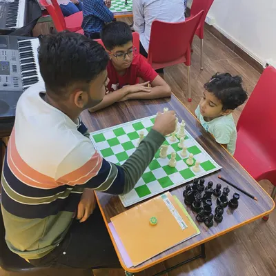 Even our youngest students are captivated by the game of chess. Here, an instructor guides a game, showing how we provide personalized coaching to players of all ages and skill levels.