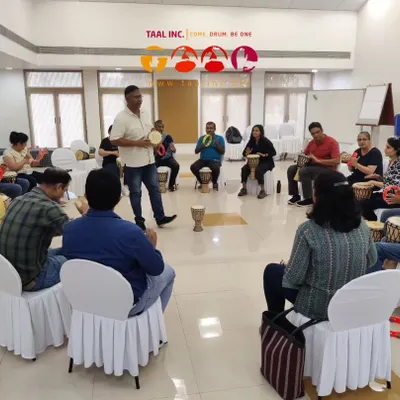 Here I am leading a corporate training session. We use group drumming as a powerful metaphor to explore leadership, team dynamics, and communication in a way that is engaging and fun.