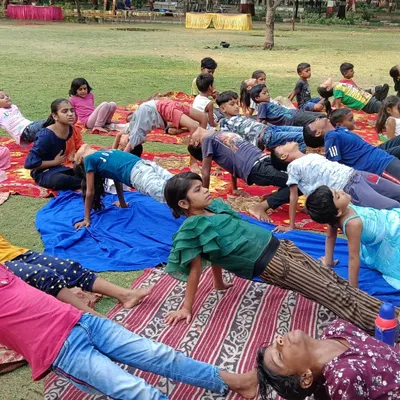 Children from a local NGO practicing Purvottanasana (Upward Plank Pose) during our International Yoga Day celebration. This asana is great for strengthening the arms, wrists, and legs.