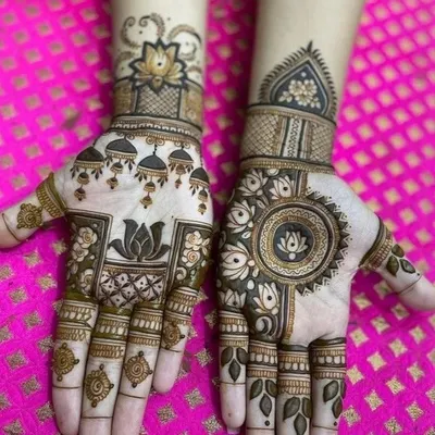 A beautiful design featuring a central mandala on one hand and hanging 'jhumki' motifs on the other. Both hands are tied together with the common element of the lotus flower.